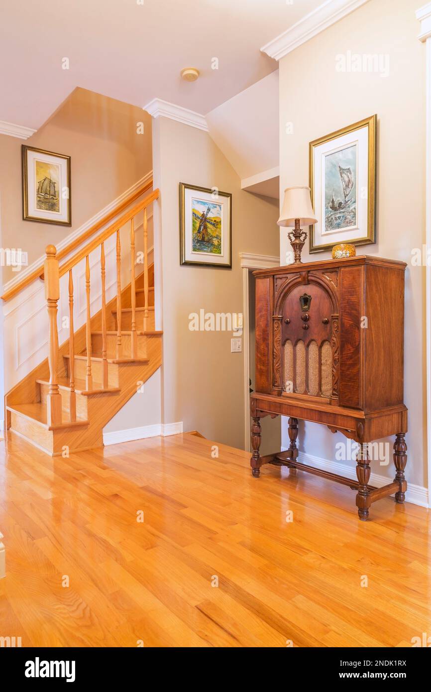 Antique 1932 radio in hallway with oak wood floorboards and staircase