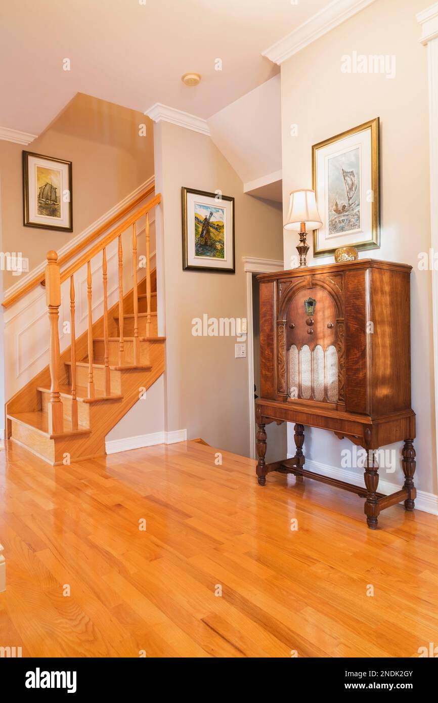 Antique 1932 radio in hallway with oak wood floorboards and staircase
