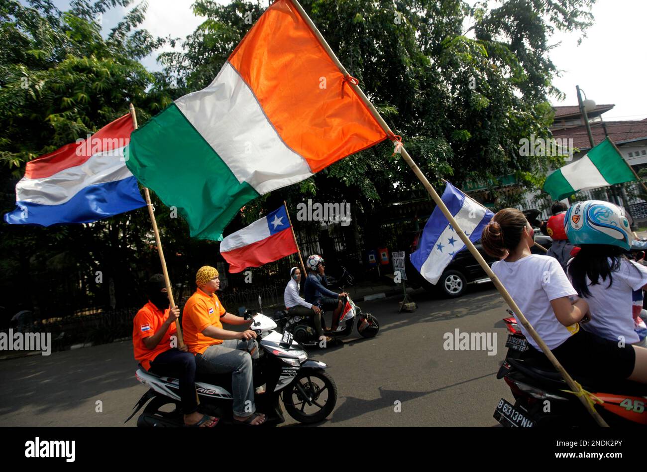 Indonesian soccer fans display flags of World Cup participants in a