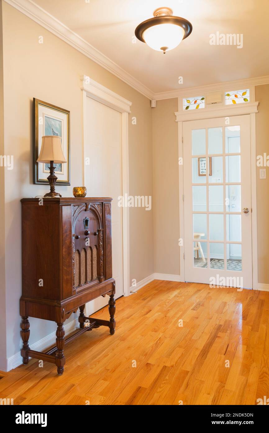 Antique 1932 radio in hallway with oak wood floorboards leading to