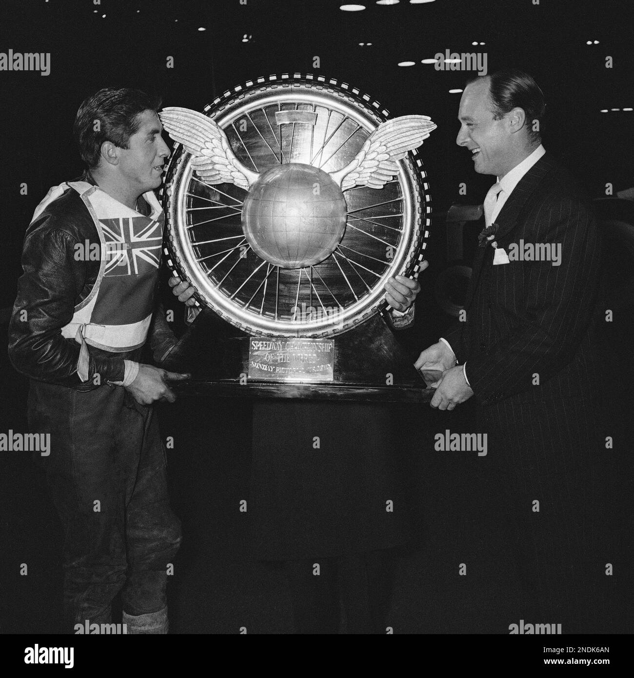 World water speed record holder Donald Campbell, right, presents the trophy to New Zealander