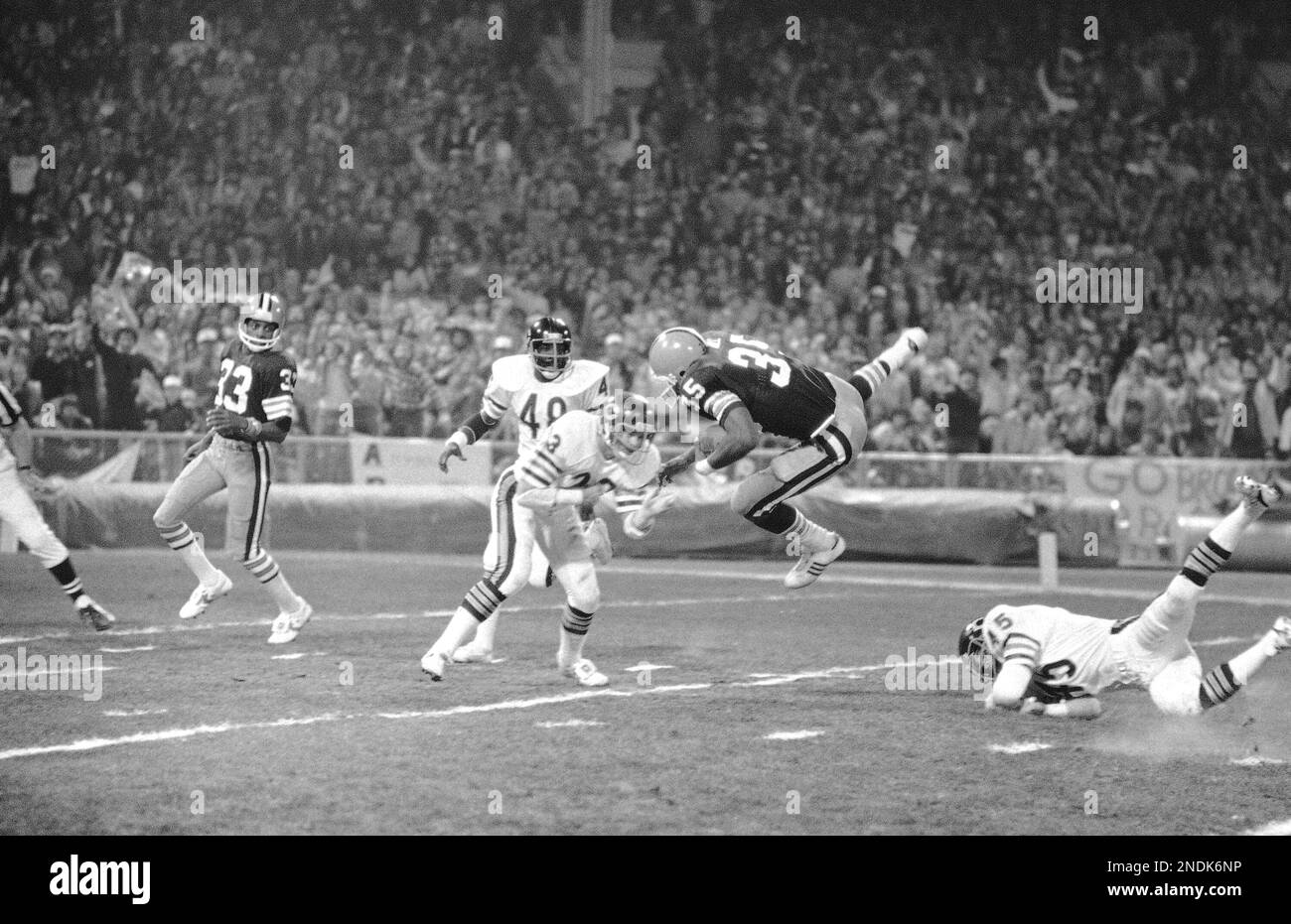 Cleveland Browns running back Calvin Hill, right, leaps to avoid the tackle  of Chicago Bears safety Lenny Walterscheid in the first quarter of game in  Cleveland, Nov. 3, 1980. Hill ran to