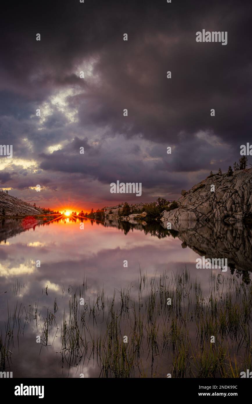 Dramatic sunset over Evolution Lake along the Pacific Crest Trail. Stock Photo