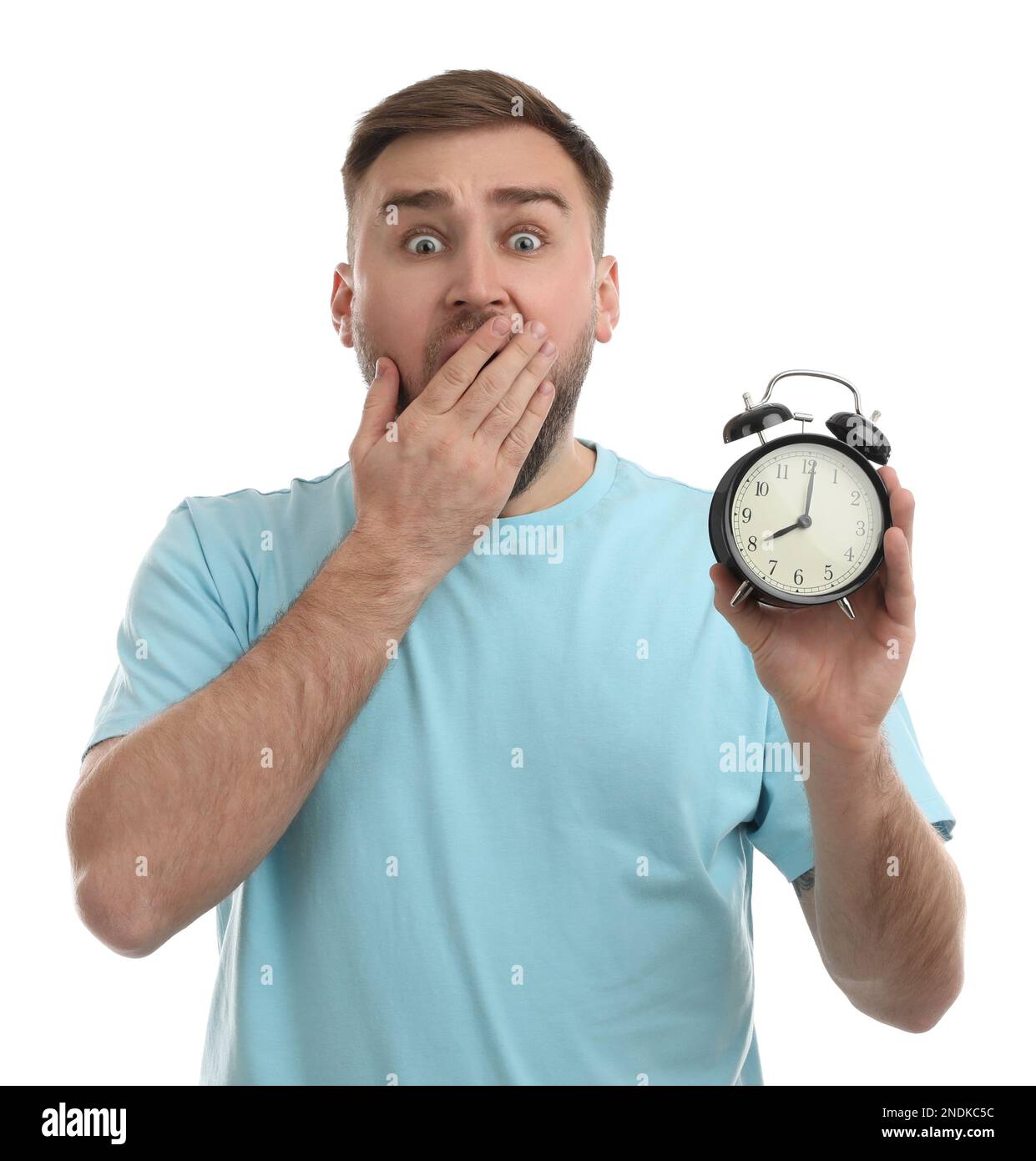 Emotional overslept man with alarm clock on white background. Being