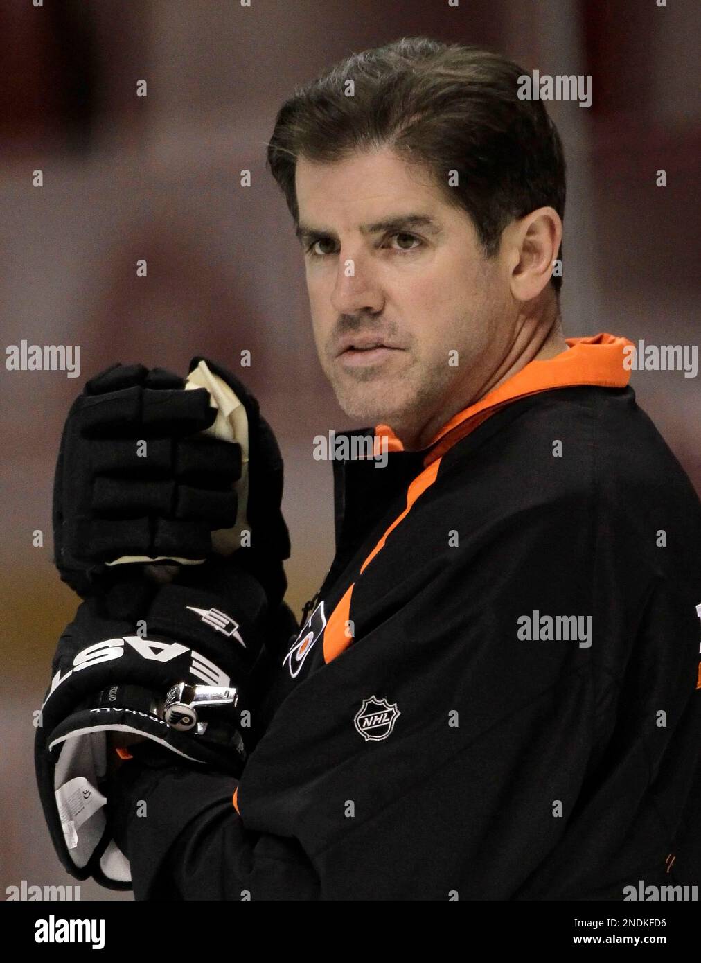 Philadelphia Flyers head coach Peter Laviolette watches during practice