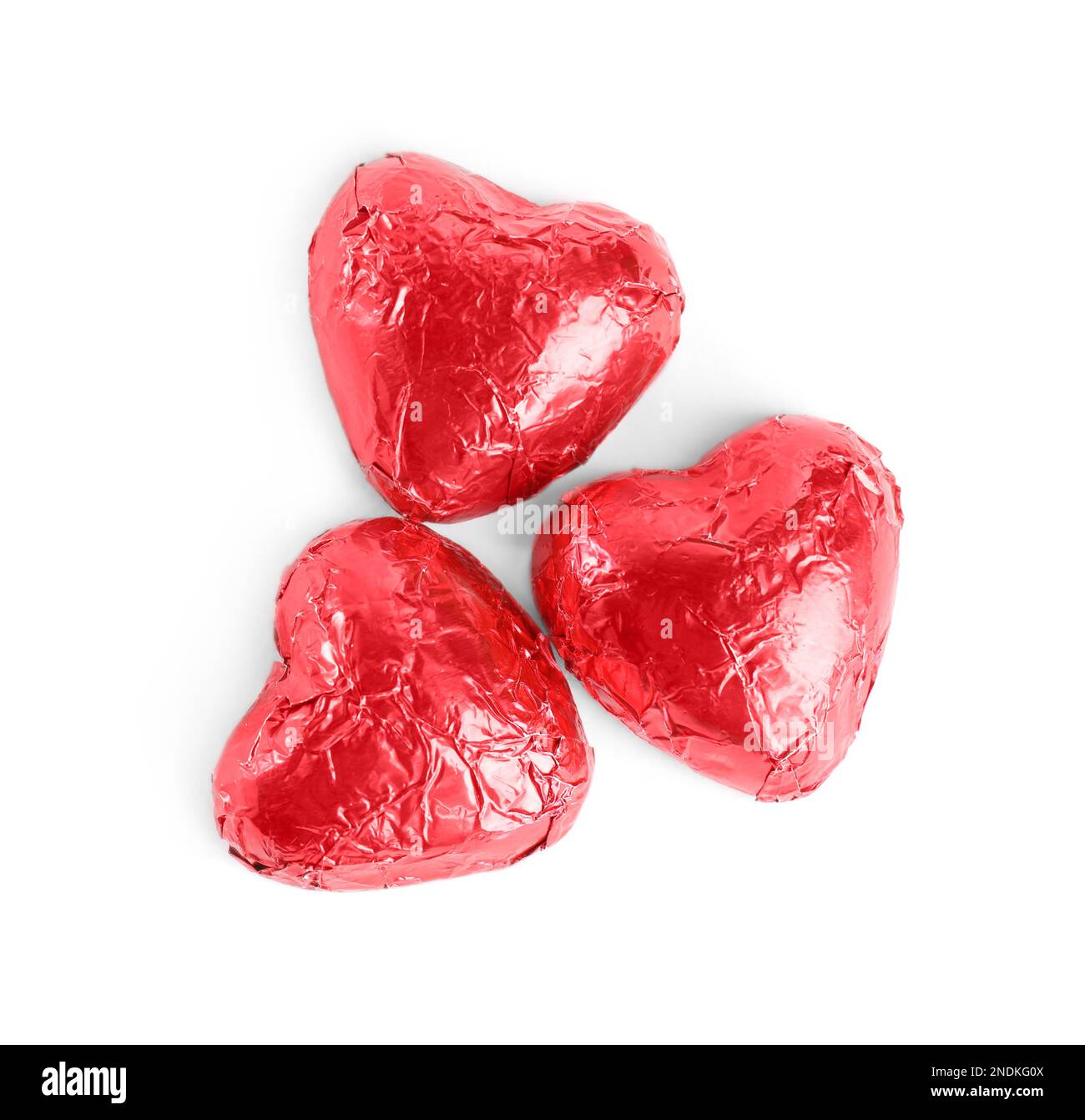 Heart shaped chocolate candies on white background, top view Stock