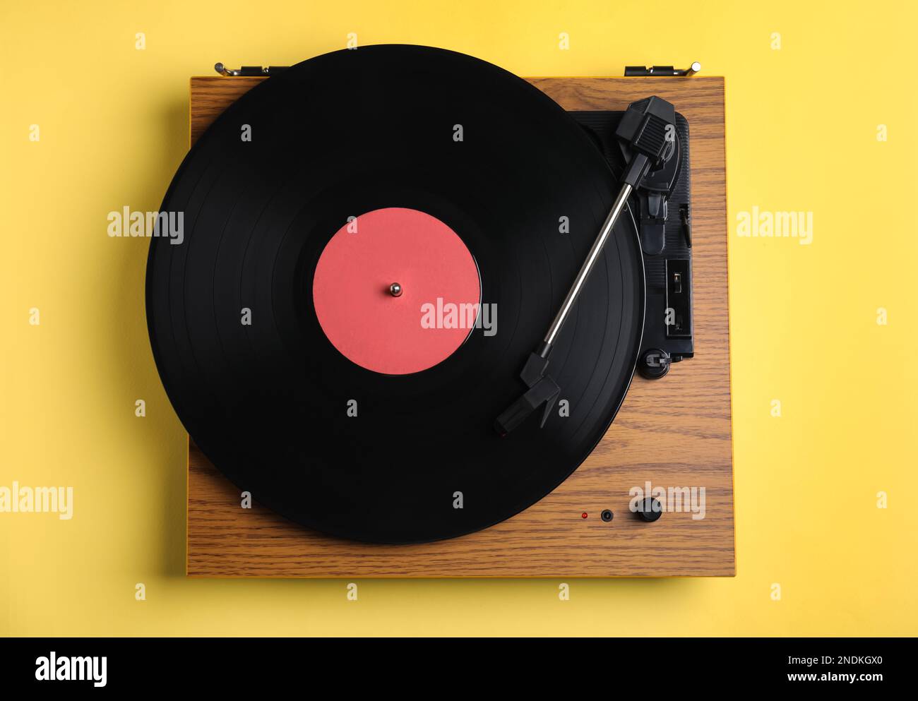 Modern Vinyl Record Player With Disc On Yellow Background Top View