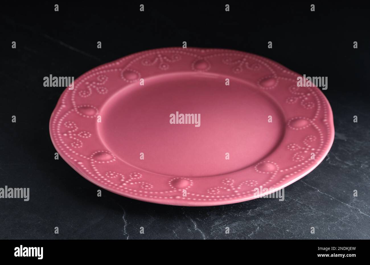 New clean plate on black slate table Stock Photo