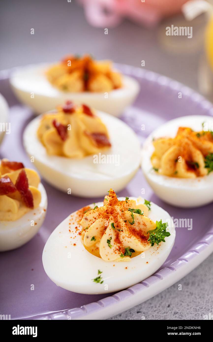 Deviled eggs with bacon and smoked paprika for Easter brunch Stock Photo
