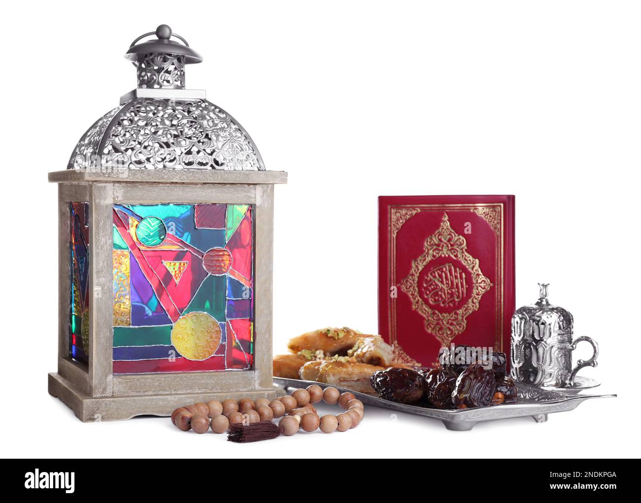 Decorative Arabic lantern, Quran, dates, baklava and coffee on white