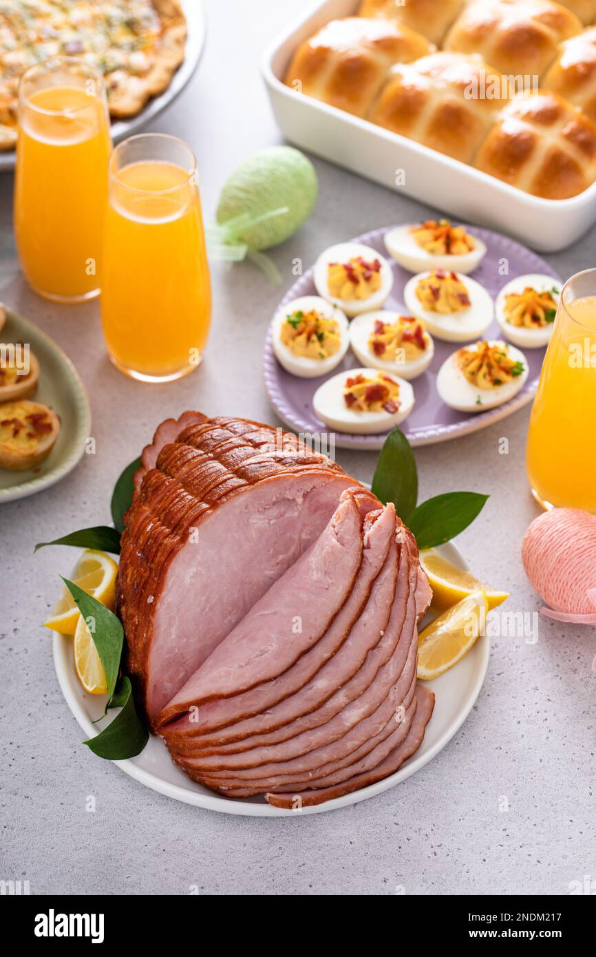 Traditional Easter ham on the table served with Easter brunch Stock Photo