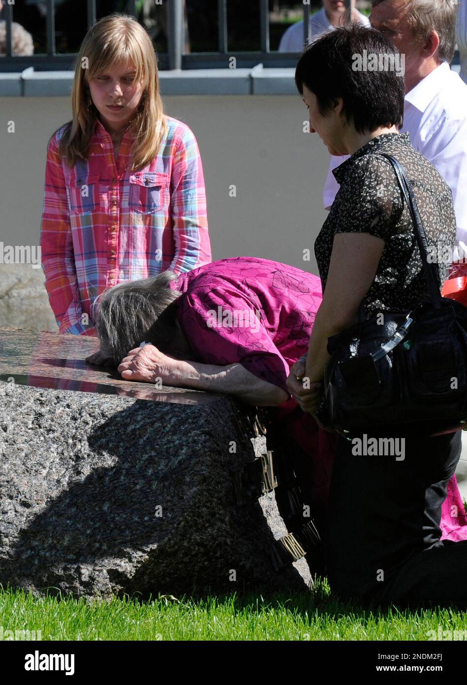 The mother of Father Jerzy Popieluszko, Marianna, center, prays at her