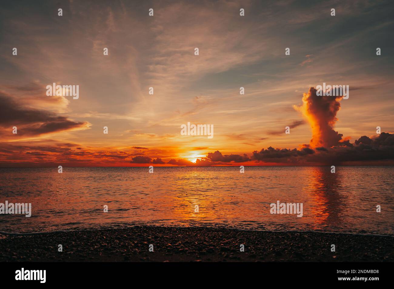 A scenic sunset over a sea Stock Photo - Alamy