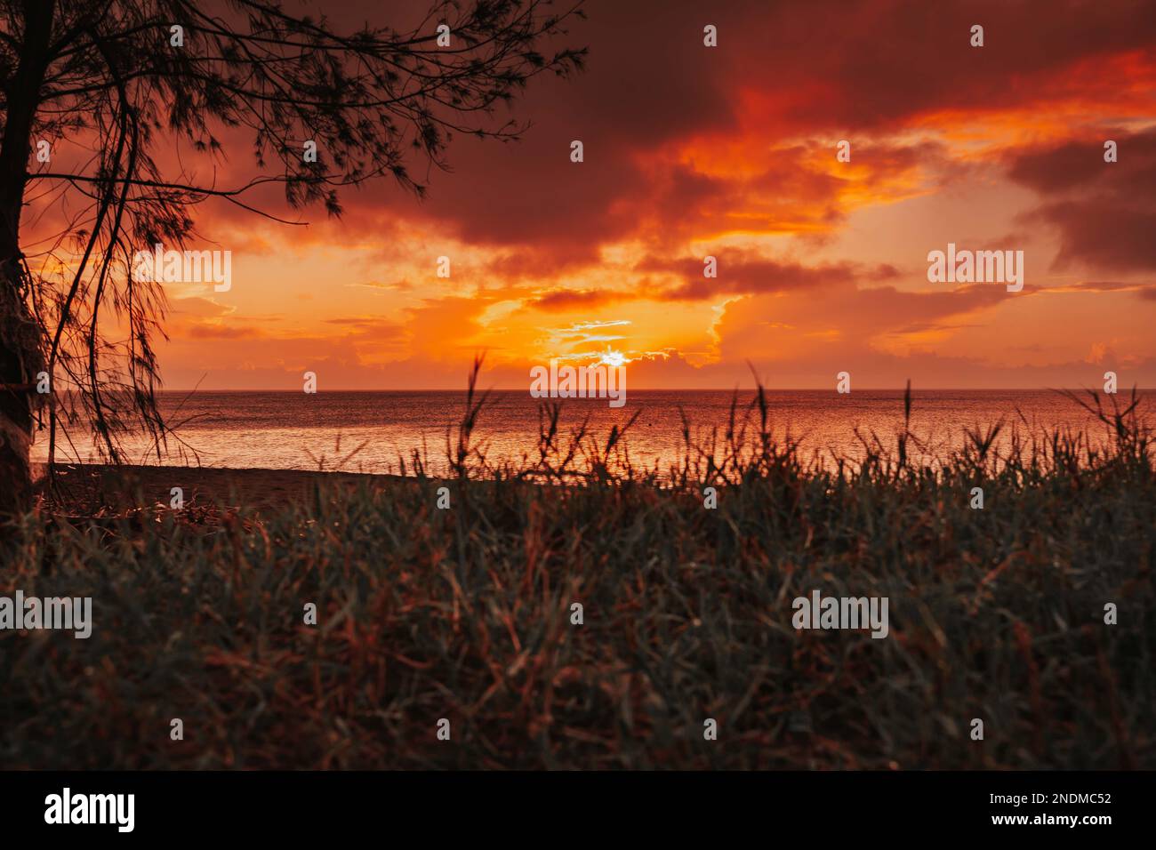 A scenic sunset over a sea Stock Photo - Alamy