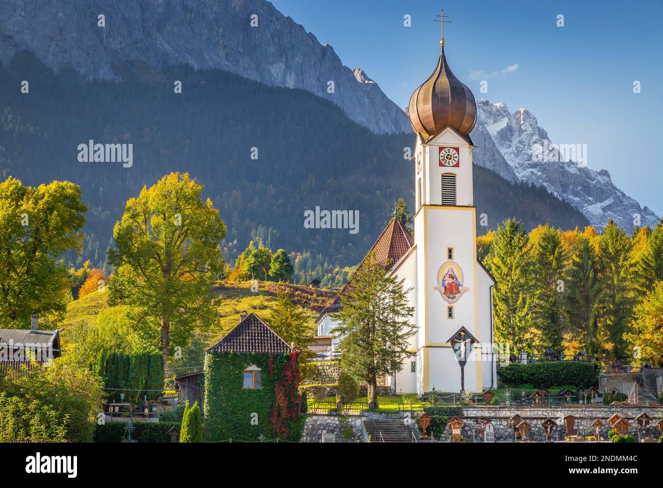 Grainau Church at golden autumn sunrise and Zugspitze massif, Bavarian alps , Germany Stock Photo