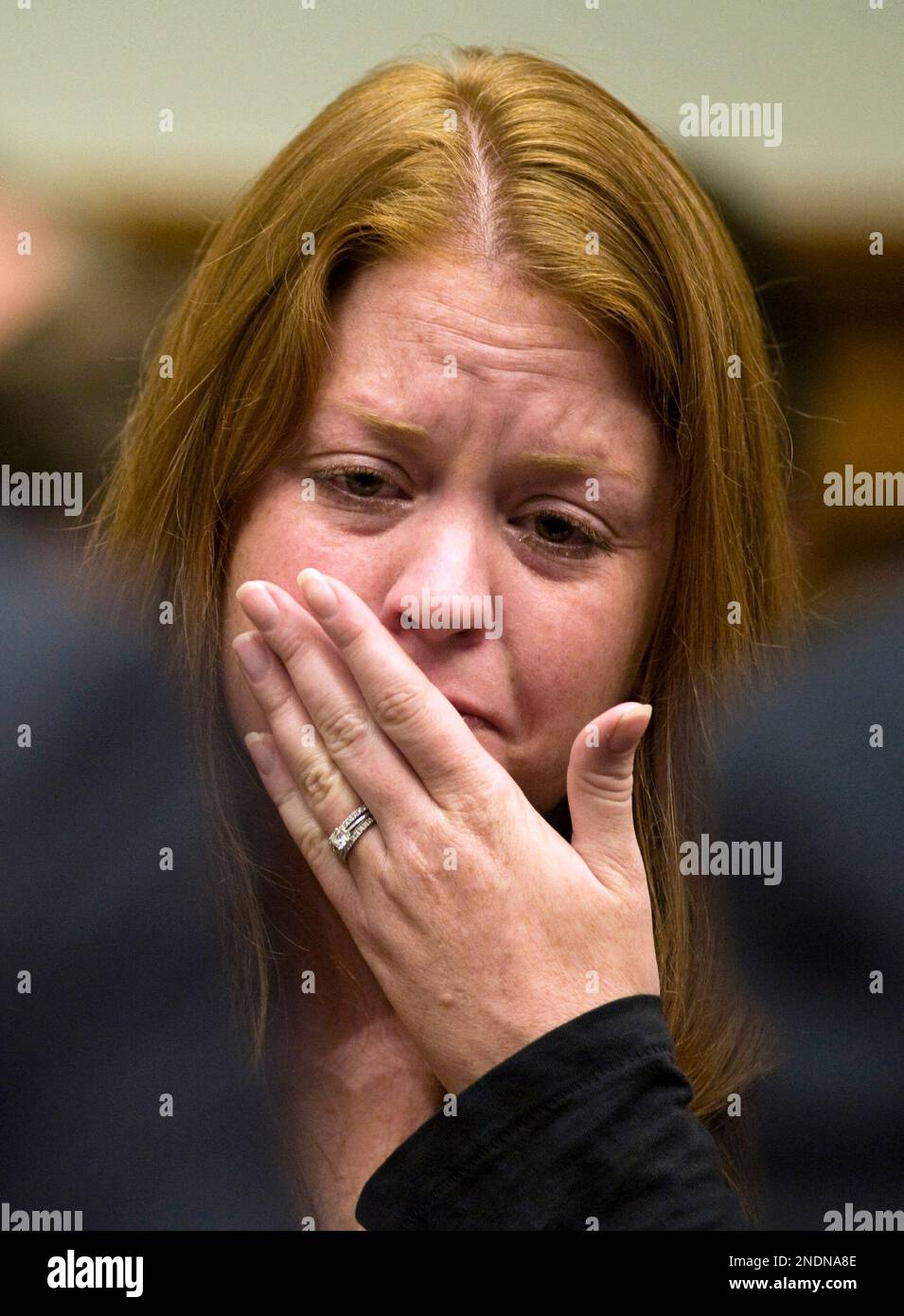 Sara Stone sits behind her husband, Stephen Stone, a Transocean, Ltd.  employee and survivor of Deepwater Horizon explosion, as he testifies on  Capitol Hill in Washington, Thursday, May 27, 2010, before the