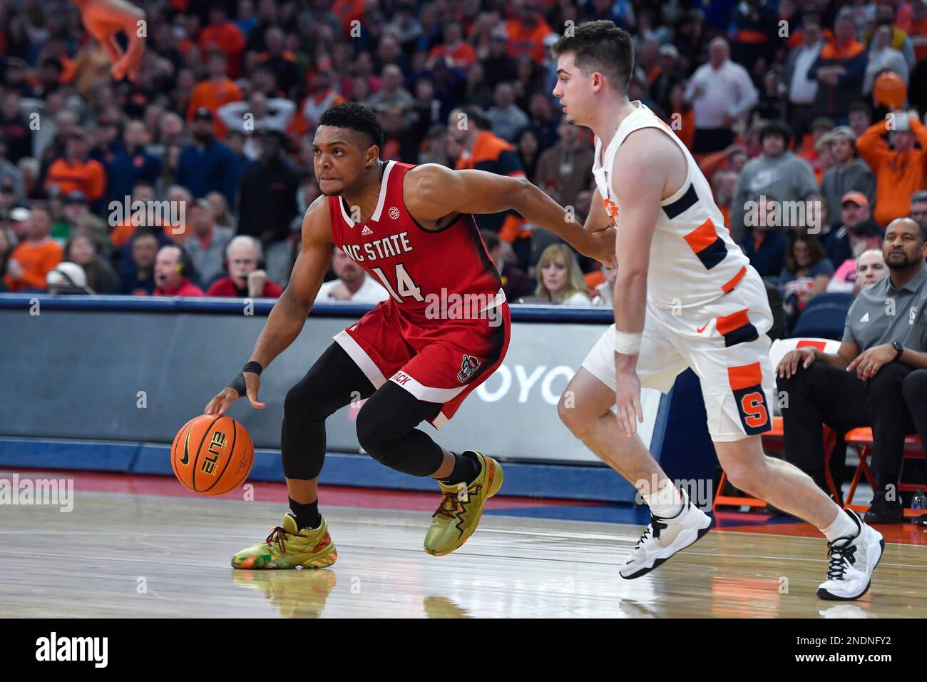 North Carolina State guard Casey Morsell, left, drives past Syracuse