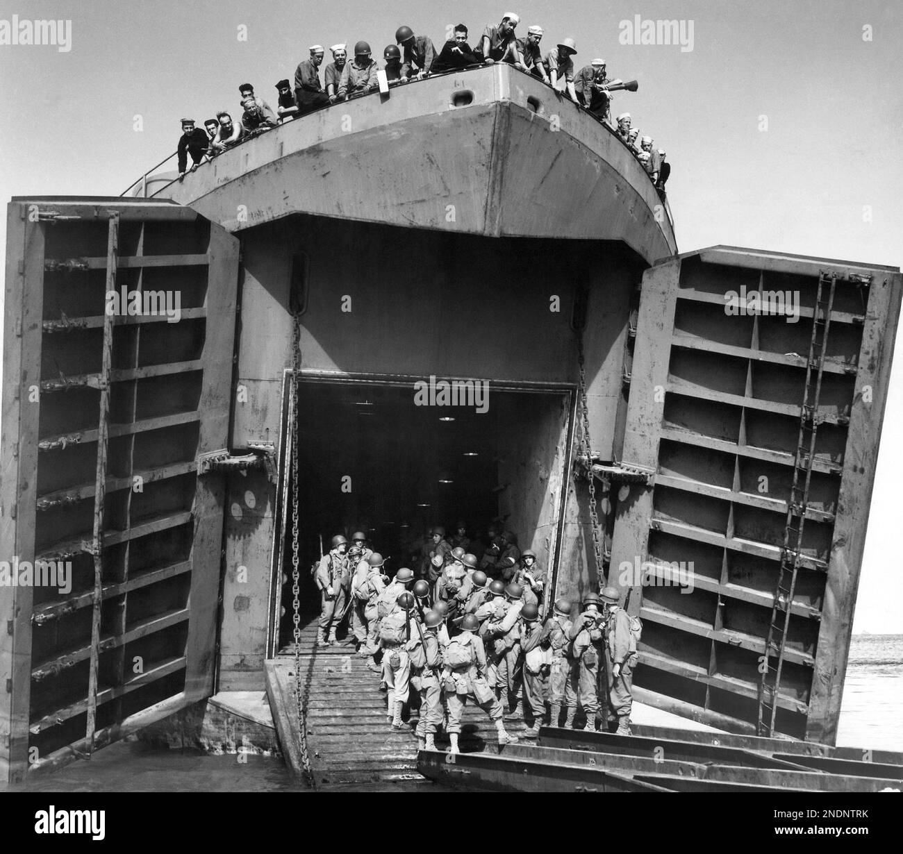 American troops enter the yawning door of an LST (Landing Ship Tanks
