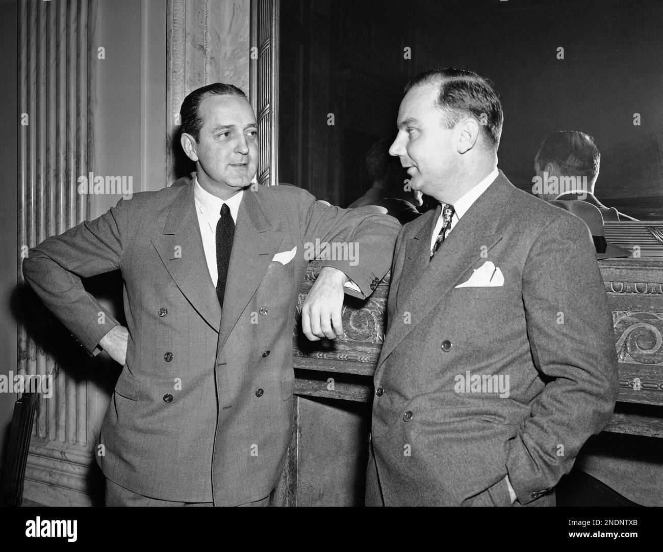 Preston Tucker, left, Chicago auto builder, talks with D.W. Holloman, his  attorney, in Washington, Nov. 20, 1950, as he appeared at a hearing before  the War Investigating committee. (AP Photo/Herbert K. White