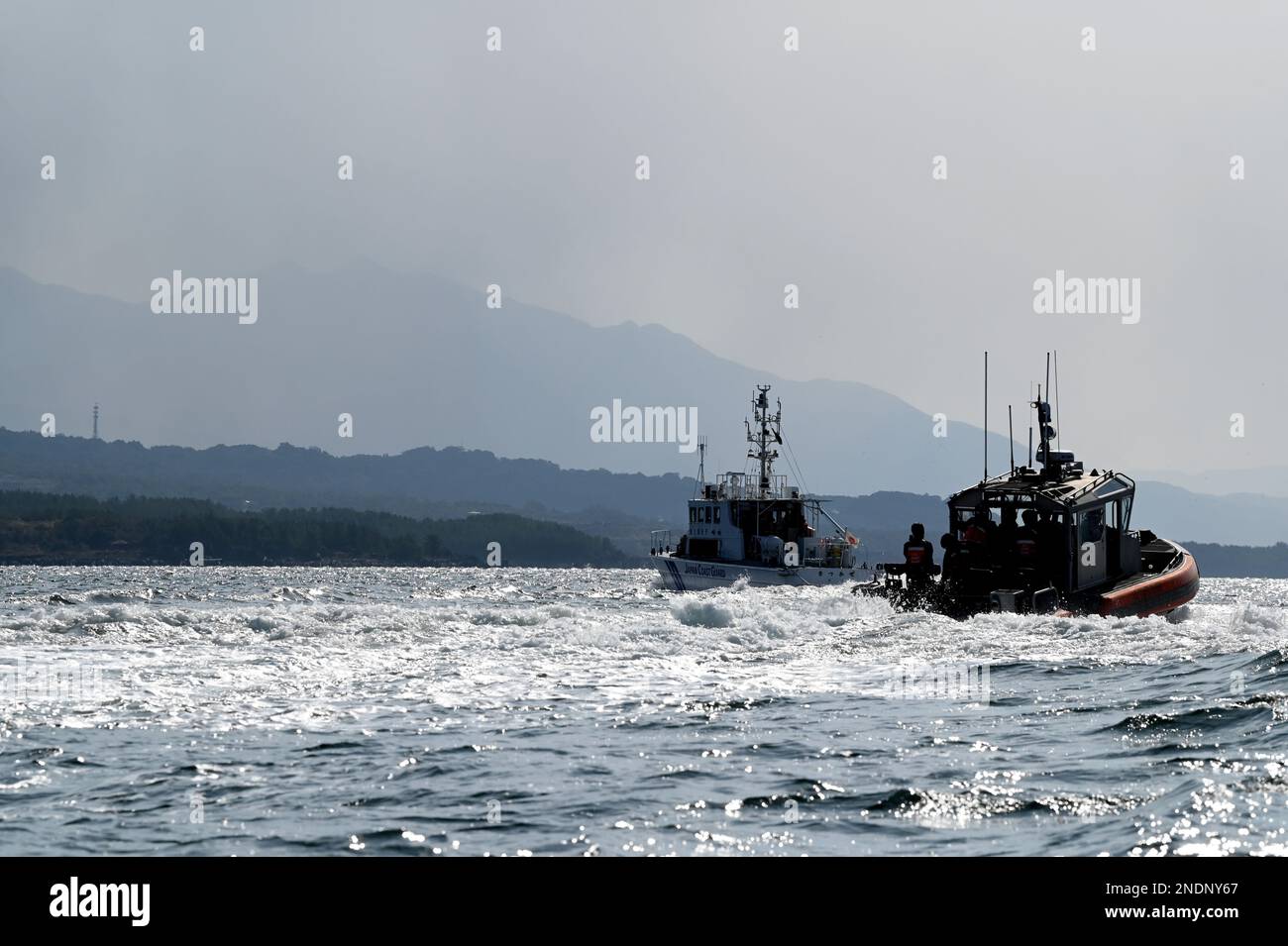 Crews aboard the Japan Coast Guard patrol craft Satsukaze and the U.S. Coast Guard Cutter Kimball’s (WMSL 756) 35-foot long range interceptor small boat depart Kagoshima, Japan, to conduct a search-and-rescue exercise in Kagoshima Bay, Feb. 14, 2023. Kimball’s crew are in Kagoshima to conduct joint training and professional exchanges with members of the Japan Coast Guard expanding on a memorandum of cooperation signed in 2022 between the two sea services which established Operation SAPPHIRE, a perpetual operation to strengthen relationships, increase bilateral engagements, and focus on maintai Stock Photo