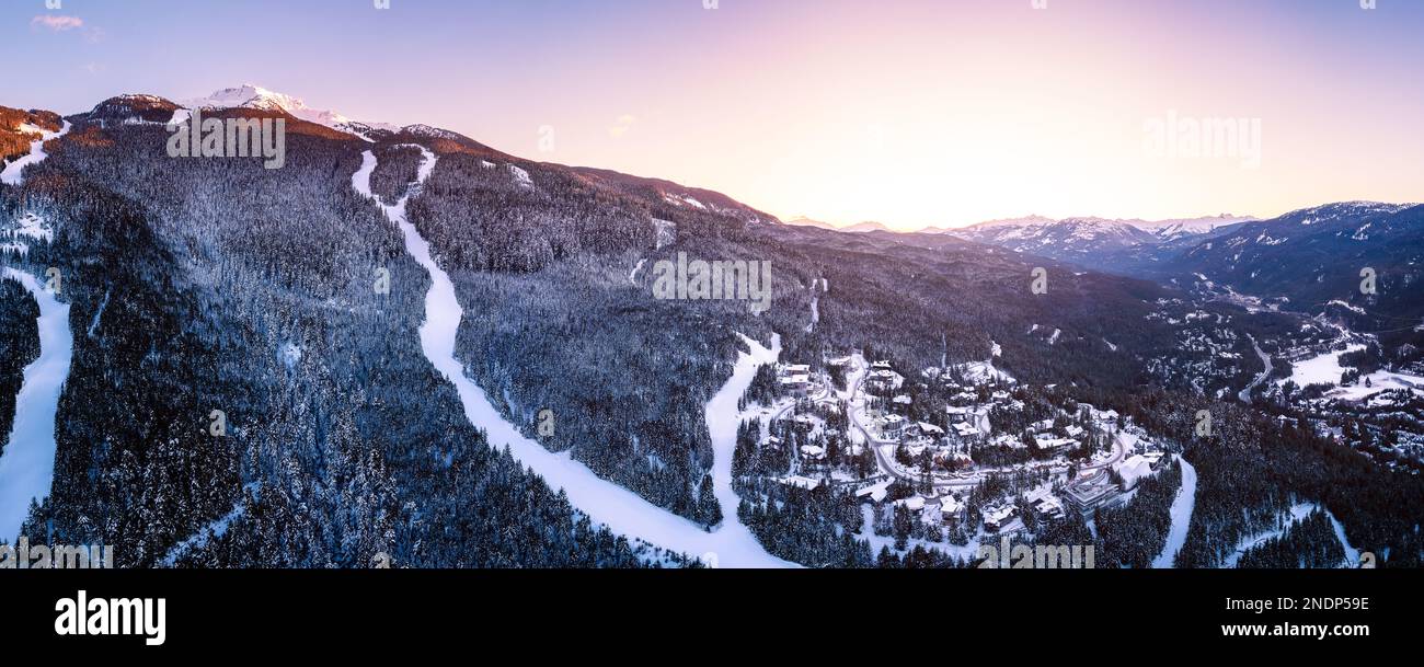Alpine homes on hill at sunset, Whistler Mountain, aerial footage