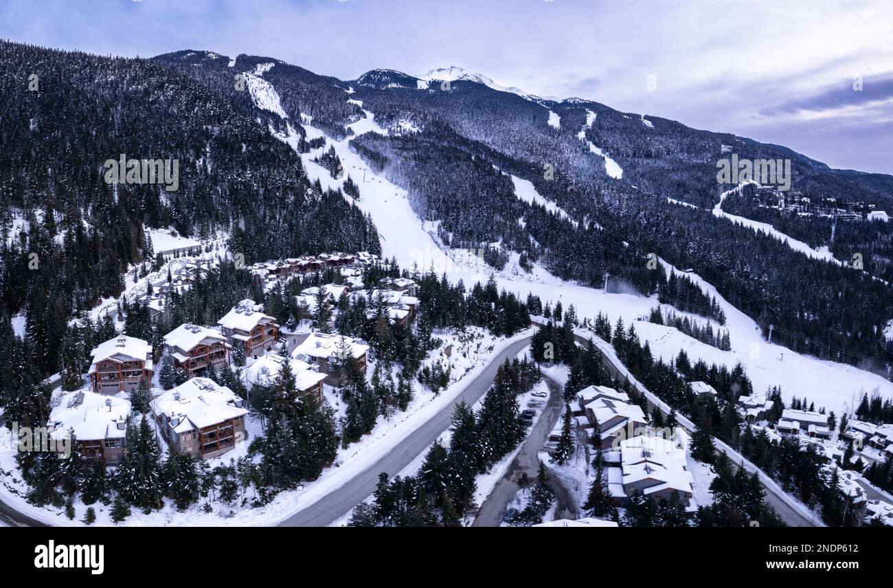 Alpine homes on hill, Whistler Mountain, aerial footage, winter scene