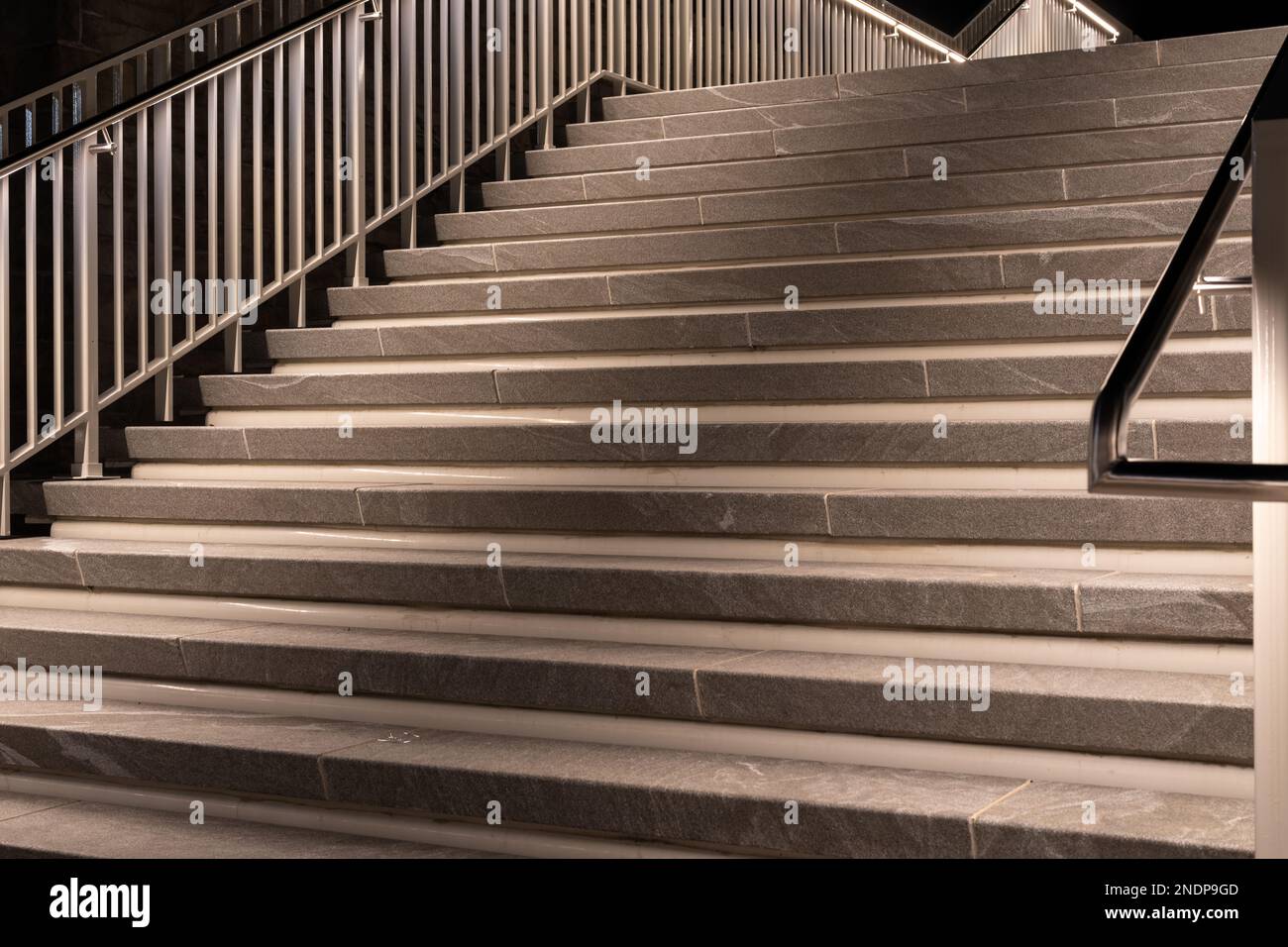 Evening photos of exterior, outdoor building granite steps with hand railing with ambient