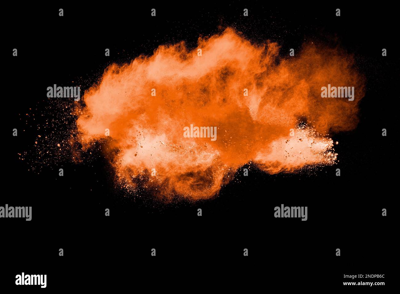 Orange powder explosion on black background. Orange color dust splash