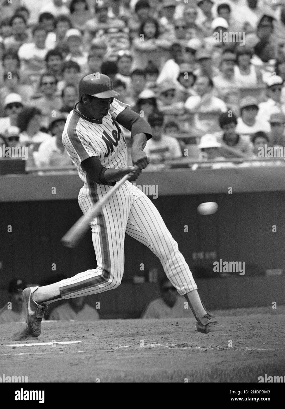 New York Mets Dwight Gooden eyes a pitch before getting a single