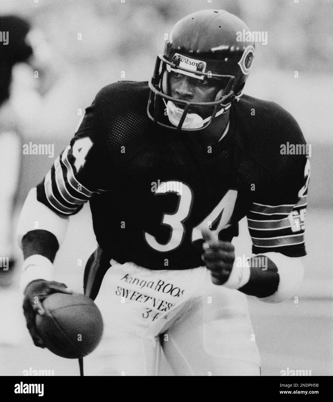 Walter Payton of the Chicago Bears carries the ball against New