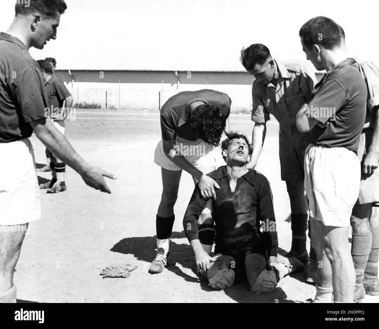 Time out for an injury in a soccer game between British soldiers and