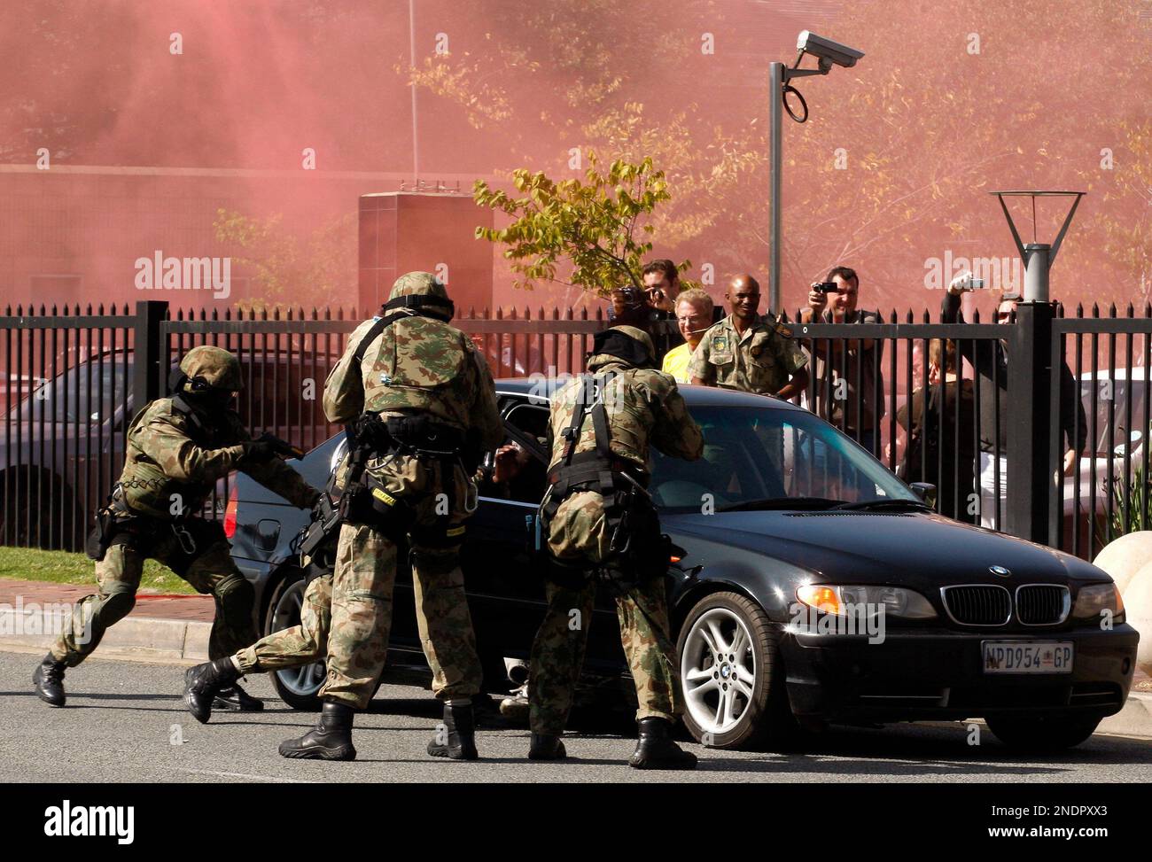 South Africa's police special task force point guns at a carjacker ...