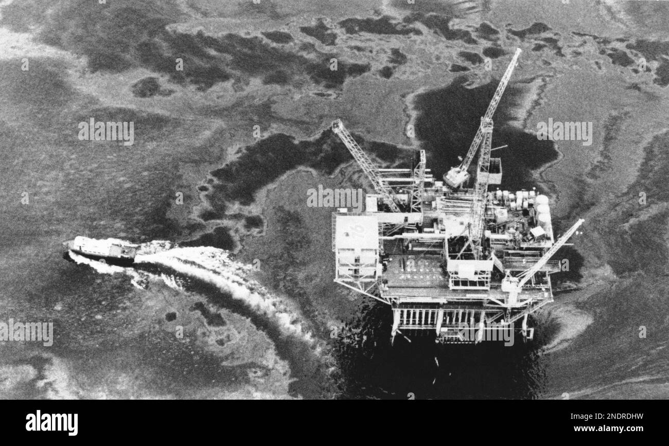 An offshore oil drilling rig surrounded by a crude oil slick, 1969. (AP ...