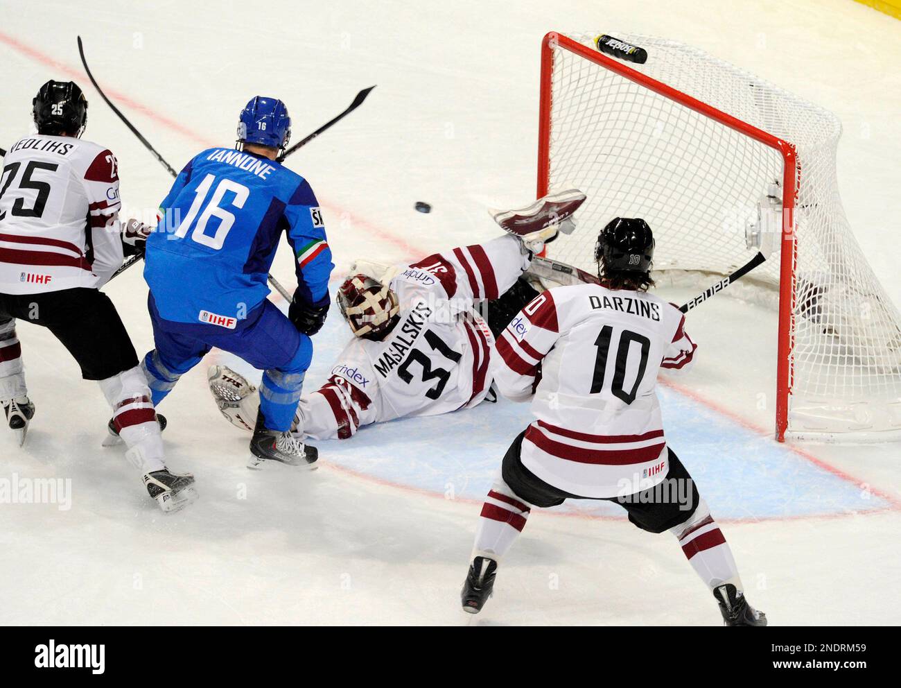 Latvia's goalkeeper Edgars Masalskis, center, fails to defend for the