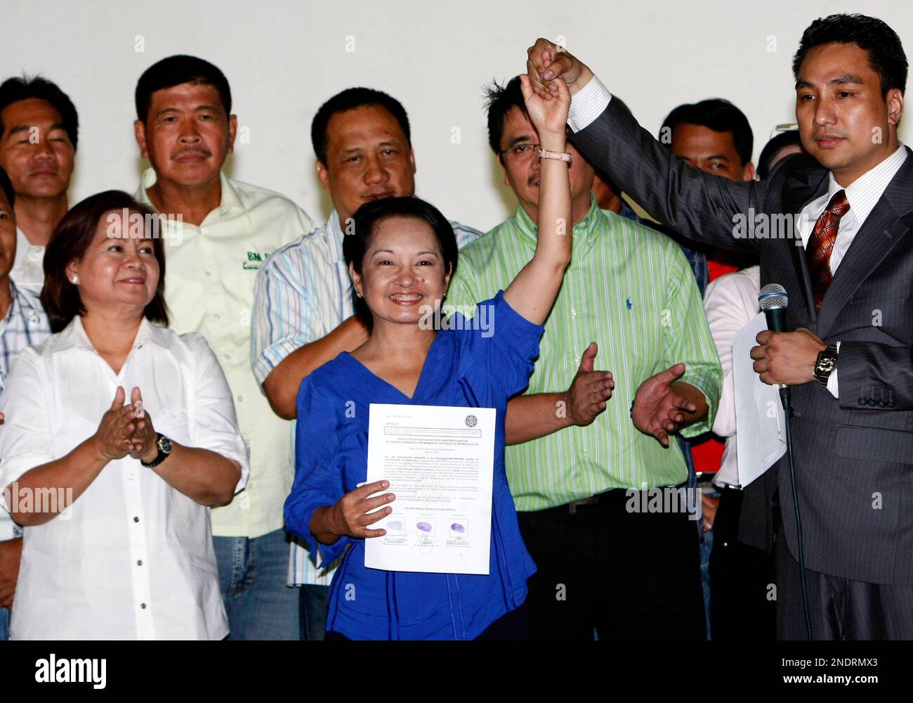 Philippine President Gloria Macapagal Arroyo, center, holds her