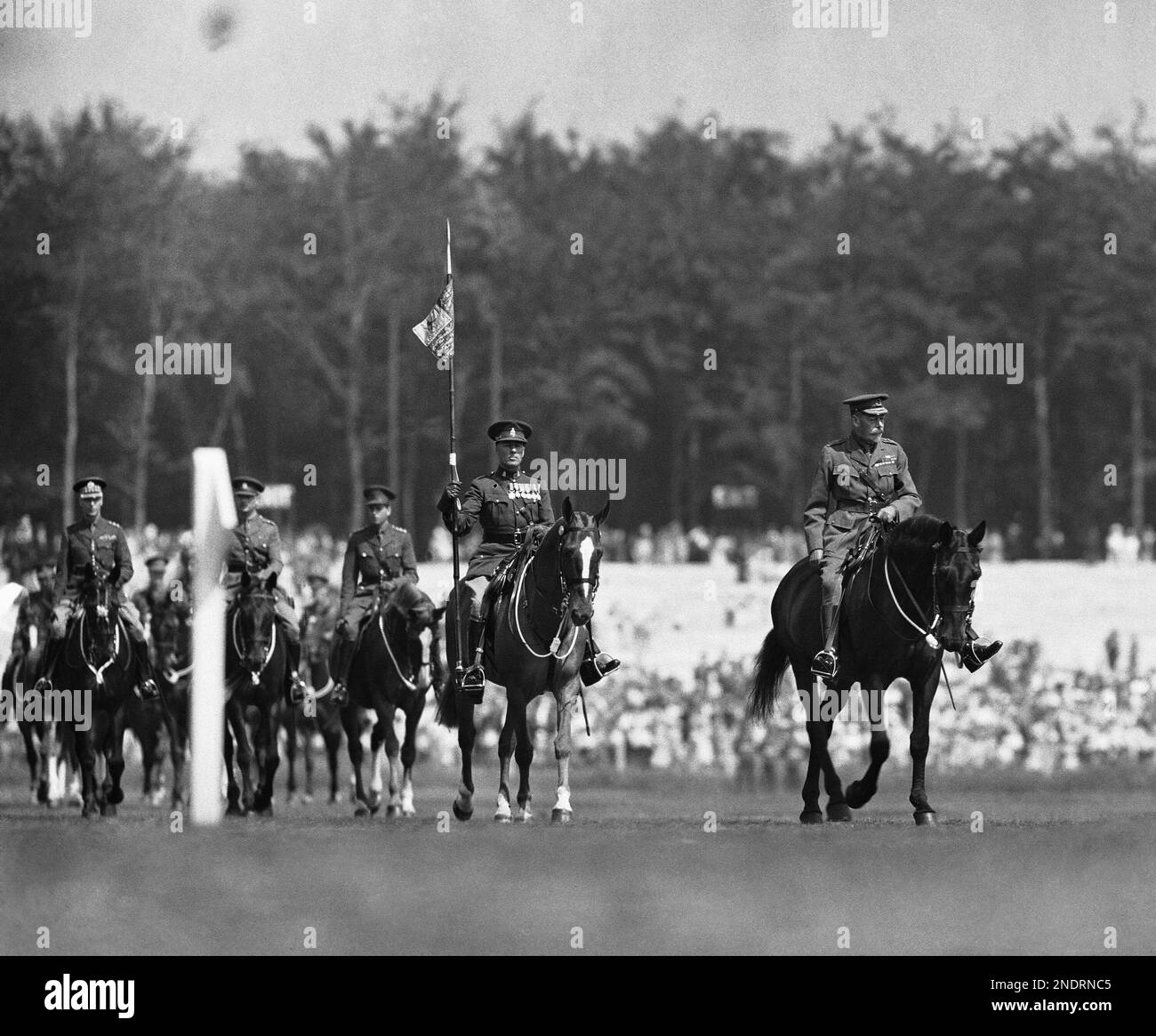 Britain's King V, right, on horseback arriving at Rushmoor Arena at Aldershot, England on