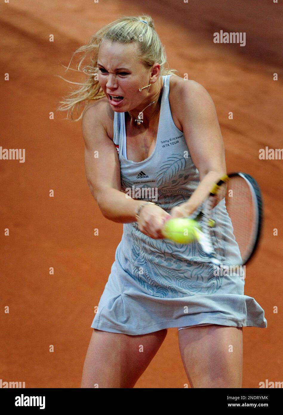 Caroline Wozniack from Denmark returns the ball during her match