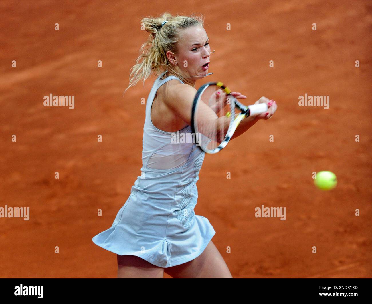 Caroline Wozniack from Denmark returns the ball during her match
