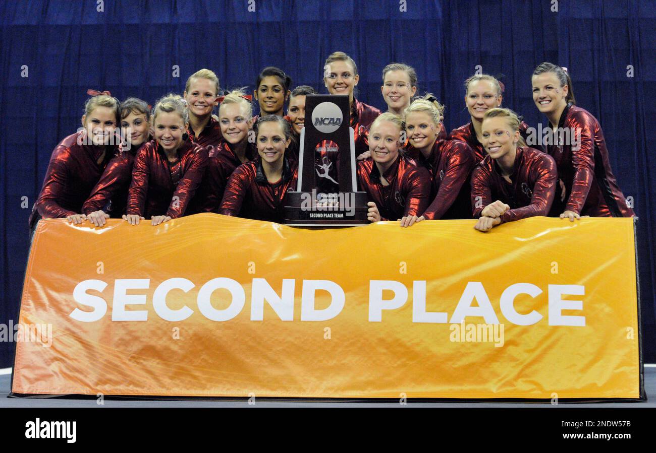 Oklahoma's women gymnasts pose with the second-place trophy after ...