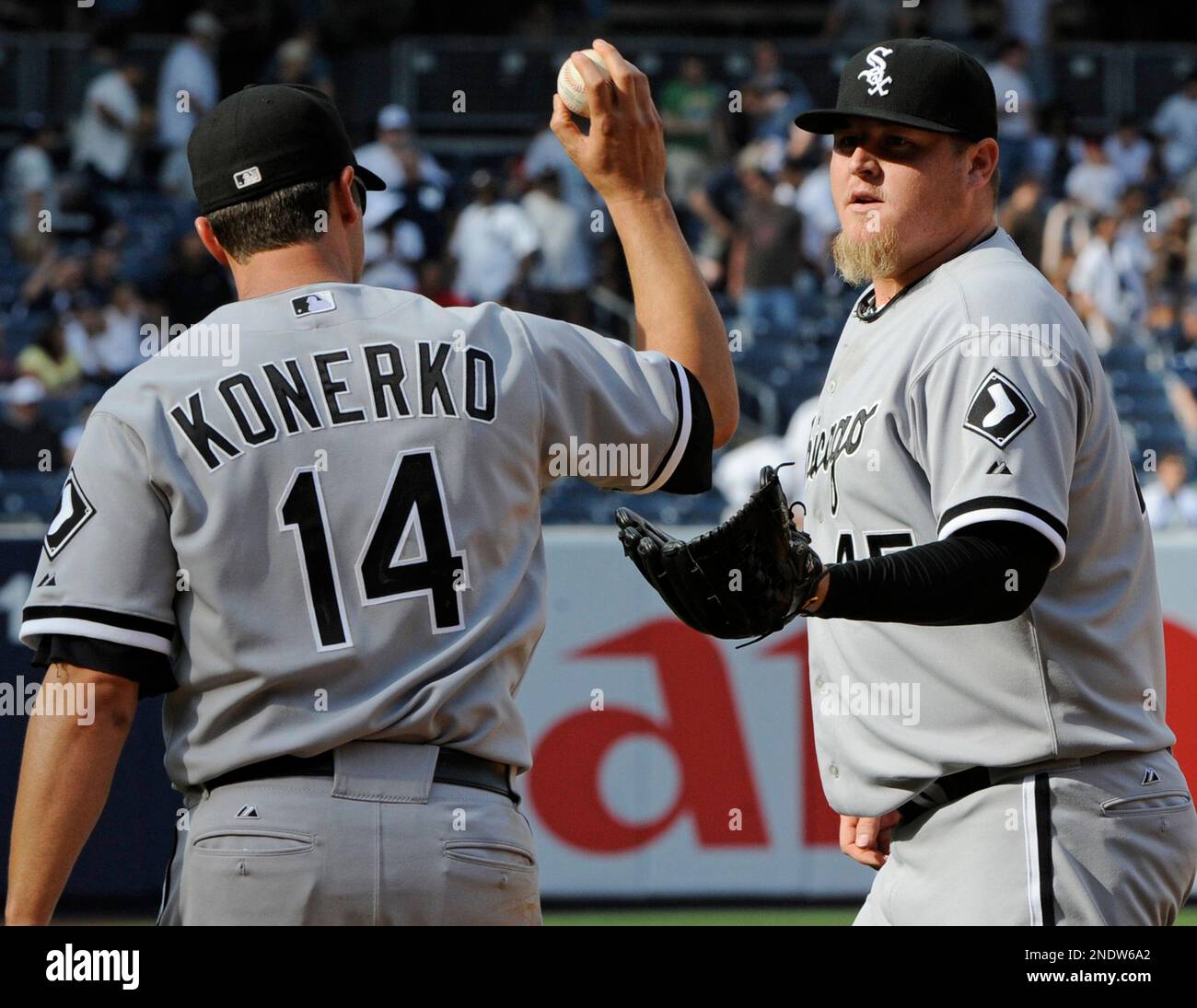 Chicago White Sox first baseman Paul Konerko, left, gives the ball to pitcher Bobby Jenks after he got the save as the White Sox beat the New York Yankees 7-6 in a baseball game Saturday, May 1, 2010 at Yankee Stadium in New York. (AP Photo/Bill Kostroun) Stock Photo