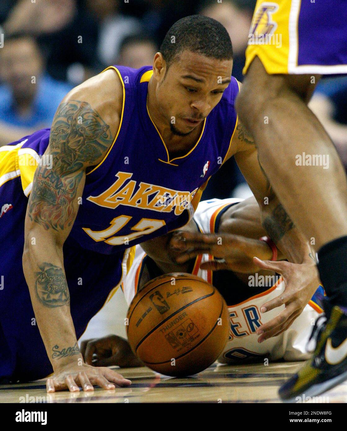 Los Angeles Lakers guard Shannon Brown, left, grabs a loose ball in front  of Oklahoma City Thunder forward Serge Ibaka, of Congo, in the second  quarter of Game 6 of a first-round