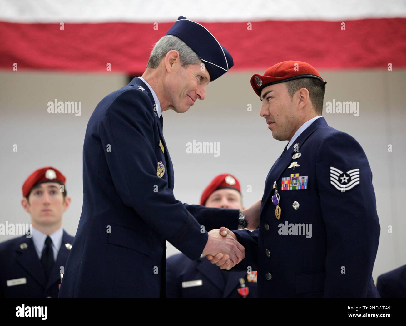 U.S. Air Force Tech. Sgt. Marc Tirres right receives the Purple Heart medal from Air Force Chief of Staff Gen. Norton Schwartz left during a ceremony Thursday April 29 2010 at Joint