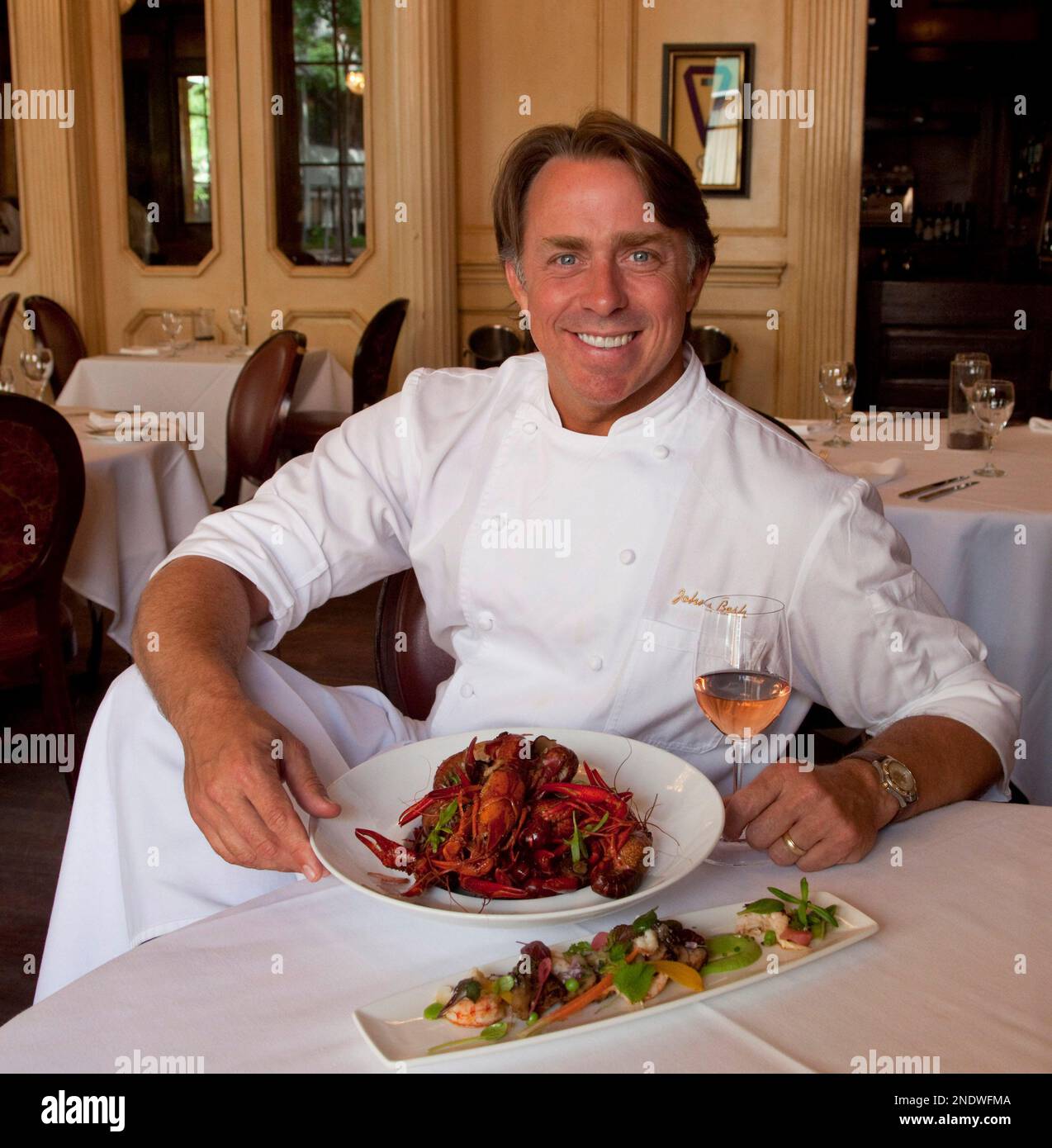 Chef John Besh poses with a "French Crawfish Boil" which consists of Spanish tarragon, Tennessee