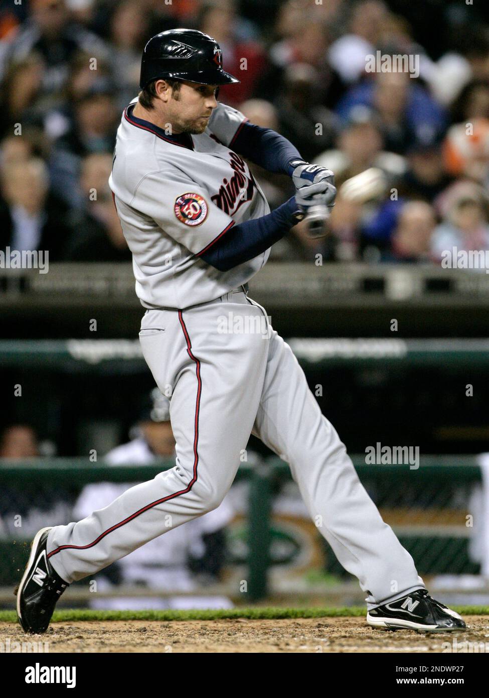 Minnesota Twins' J.J. Hardy hits a fly ball to left field in the sixth  inning of a baseball game against the Detroit Tigers Tuesday, April 27, 2010  in Detroit. Tigers' left fielder