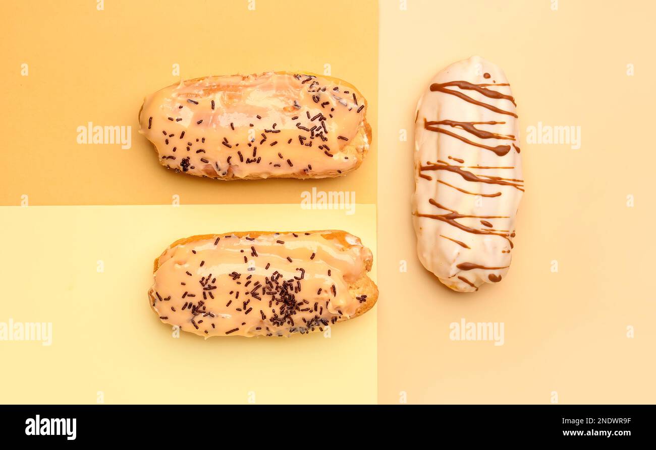 Tasty glazed eclairs on colorful background Stock Photo
