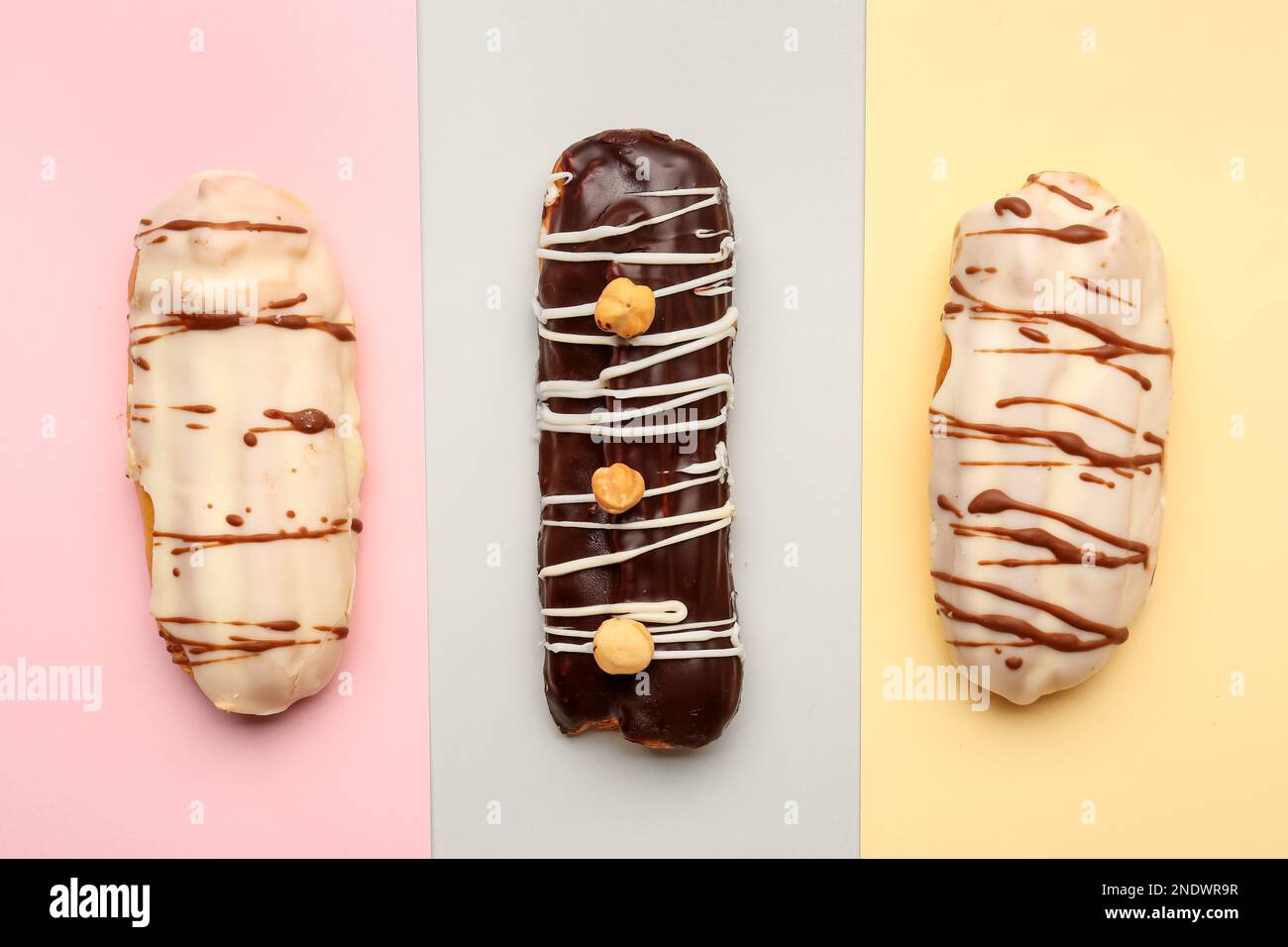 Tasty glazed eclairs on colorful background Stock Photo