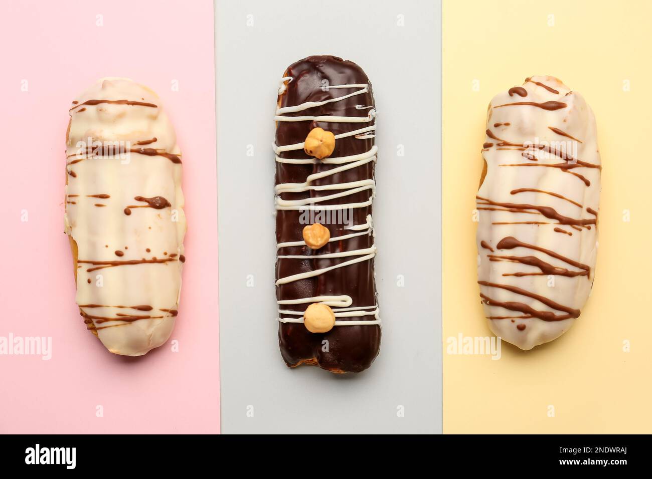 Tasty glazed eclairs on colorful background Stock Photo