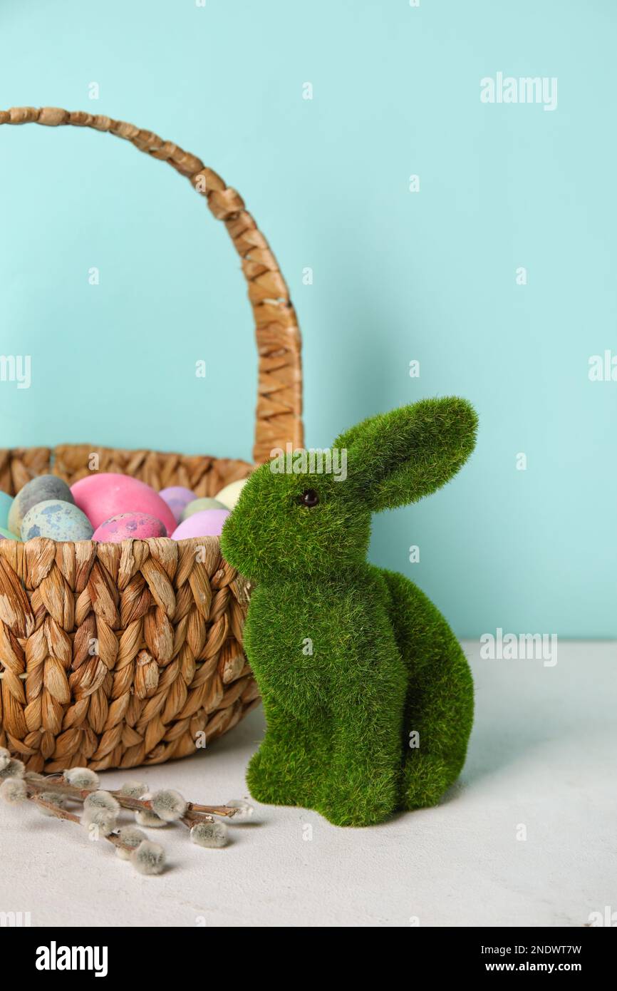 Easter bunny, basket with painted eggs and pussy willow branches on ...