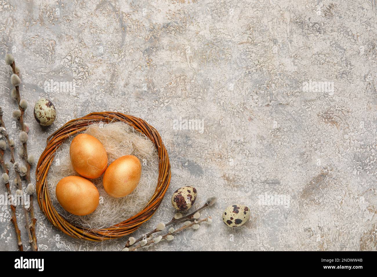 Wreath with Easter eggs and willow branches on grunge background Stock Photo