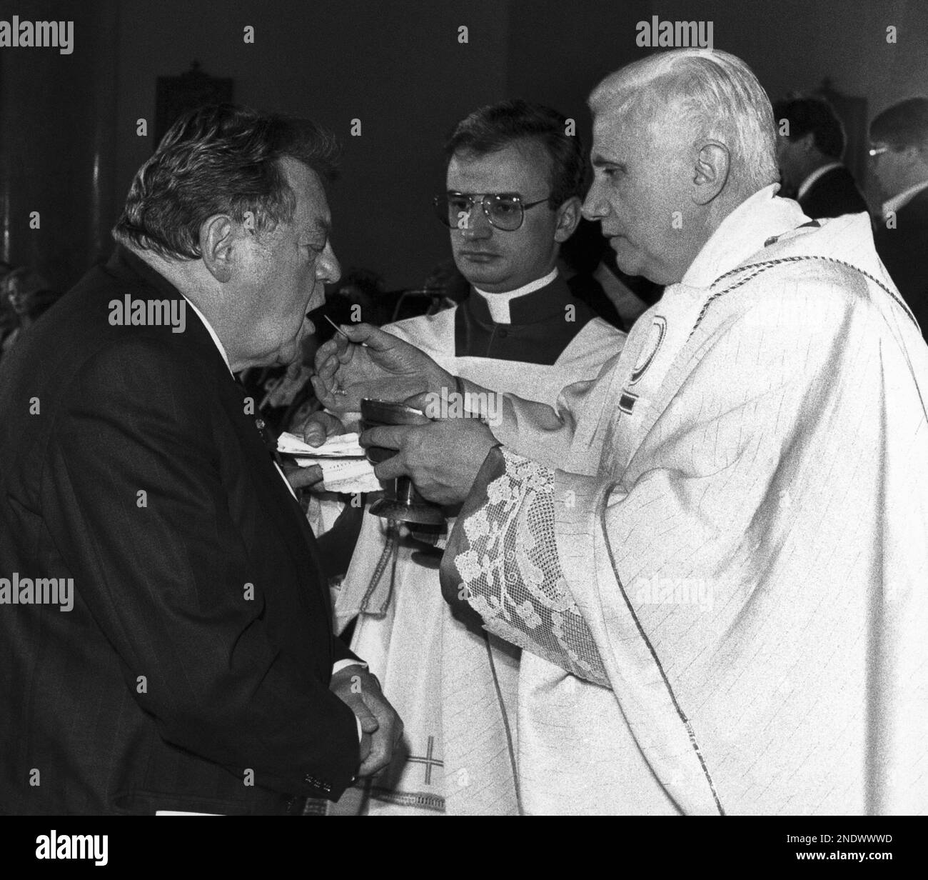 West German Cardinal Joseph Ratzinger gives holy communion to Bavarian ...